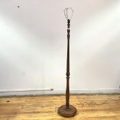 A 1940s turned wood floor lamp, the baluster stem incorporating acanthus carving, raised on a dished