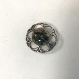 An Iona silver brooch mounted central circular moss agate stone within a circular Celtic knot (d.