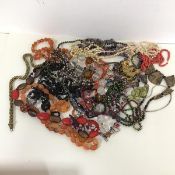 A collection of costume jewellery including glass, paste and shell necklaces, a string of