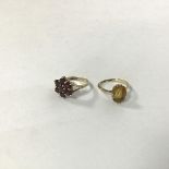 An 18ct gold ring set single cushion cut citrine in claw setting (M) (2.81g) and a 9ct gold garnet