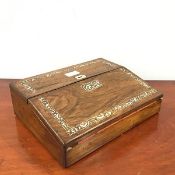 A 19thc rosewood and mother of pearl inlaid writing slope, the hinged wedge shaped top enclosing a