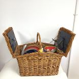 An Amberley picnic basket, the central handle flanked by two hinged lids which open to reveal a