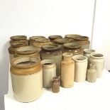 A large assortment of stoneware jars and bottles, one bottle stamped Fulham, Bailey (?), (largest: