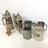 A mixed lot comprising two German ceramic beer steins, with metal lids, one includes music box, a W.