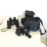 A Minolta X-700 camera with original instruction manual and a Hahnel carrying case, also a pair of
