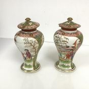 An unusual pair of English heavily potted and enamel painted vases and covers in the Chinese