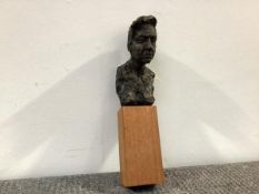 20th Century School, a small bronzed portrait bust of a man, unsigned, mounted on a wooden block.