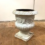 A cast-iron garden urn, of campana form, the everted rim and gadrooned body, on socle base. 49cm