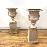 A pair of handsome cast-iron garden urns, of campana form, probably 19th century, each with