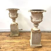 A pair of handsome cast-iron garden urns, of campana form, probably 19th century, each with