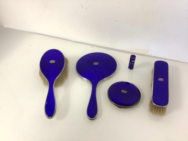 An assembled set of George V silver and blue enamel dressing table accessories, various dates and