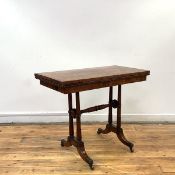A George IV rosewood card table in the manner of George Bullock, the hinged rectangular top with