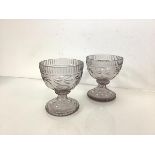 A pair of cut-glass pedestal bowls, early 19th century, possibly Irish, each bell-shaped bowl with a