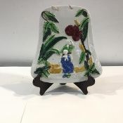 A rare Portobello pearlware plaque, c. 1820-30, of bell form, modelled with two figures amidst