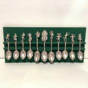 A set of eleven large Indian white metal spoons, three serving spoons and eight dessert spoons, each