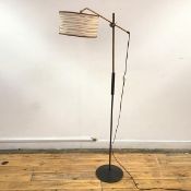 A 1950's lacquered brass, ebonised wood and steel floor lamp, stamped "DMI" and letter code, the