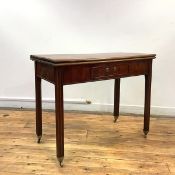 A George III mahogany foldover tea table, c. 1760, the hinged rectangular top above a frieze drawer,