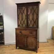 A Scottish Regency mahogany and ebony-inlaid secretaire bookcase, the projecting cornice and