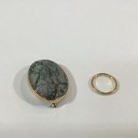 An 18ct gold wedding band; together with a 9ct gold mounted moss agate brooch. (2) Ring 3 grams,