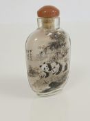 A Chinese inside-painted rock crystal snuff bottle, decorated to each side with two pandas amidst