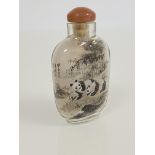 A Chinese inside-painted rock crystal snuff bottle, decorated to each side with two pandas amidst