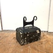 A Victorian cast iron boot scraper, mounted on a moulded stone, all black-painted. 43cm by 35cm by