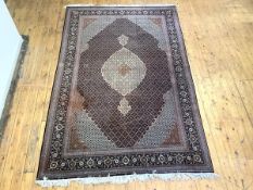 A fine hand-knotted North-West Persian carpet, the chocolate brown field with lattice motifs and