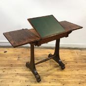 An unusual William IV rosewood library table, the rectangular hinged top enclosing a leather-lined