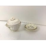 A 19th century creamware tea strainer on stand, the circular strainer with loop handle, the stand