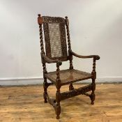 A Charles II and later armchair, the foliate carved top rail above a woven cane back and seat,