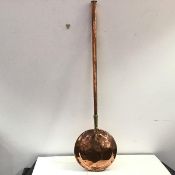An unusual 19th century copper and brass warming pan, probably Dutch, with a long tapering hollow
