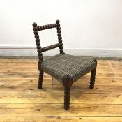 A 19th century child's bobbin chair, the rectangular back above a woven tweed seat. 48cm by 38cm