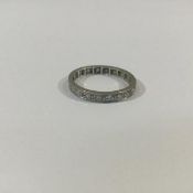 A diamond full hoop eternity ring, the white metal band (unmarked) set with approximately twenty