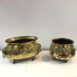 Two brass planters, c. 1900, one oval, the other circular, each with lion mask ring handles,