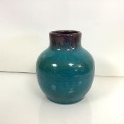 A Pilkington's Royal Lancastrian turquoise glazed vase, the neck in a purple drip glaze, shape no.