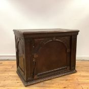 A late 17th century oak cupboard top, c. 1700, the projecting cornice above a door with arched