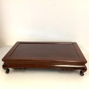 A large Chinese hardwood bonsai stand or low table, of rectangular form, with dished top, on