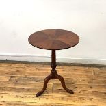 A 19th century snap top wine table, the circular top with central amboyna roundel, and radiating