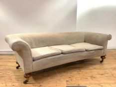 A Victorian walnut three seater sofa, the upholstered scrolling back, above three later seat