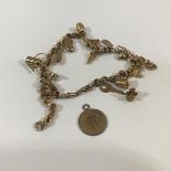 A 9ct gold charm bracelet, the fancy belcher link chain on a lobster clasp, suspending a quantity of