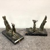 A pair of French patinated metal bookends in the Art Deco taste, each modelled as a girl lying on