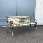 A Victorian cast-iron garden bench, the pierced ends incorporating foliate decoration enclosing a