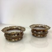 A pair of large 19th century electro-plated bottle coasters, each with shell, scroll and grape-