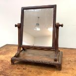 A Regency mahogany toilet mirror, attributed to Gillows, the rectangular plate within scroll