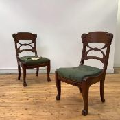 A pair of mahogany French Empire Revival dining chairs, each tablet top rail with carved scrolling