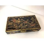 A Chinese Export black and gilt-lacquer games box, early 20th century, rectangular, fitted with five