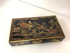 A Chinese Export black and gilt-lacquer games box, early 20th century, rectangular, fitted with five