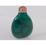 A Chinese carved malachite snuff bottle, of flattened oval form, with pink quartz stopper. 5.5cm