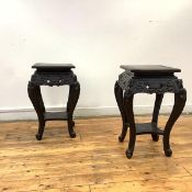 A pair of Chinese ebonised jardiniere stands, early 20th century, each square top above a pierced