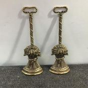 A pair of cast brass doorstops in 19th century style, each cast as a wheatsheaf on a ribbon-bound